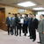 西村大臣（左３人目）に提言書を手渡す小渕会長（左４人目）